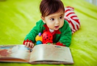 The small girl looking at book 