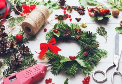 Prepare for xmas. Handmade craft wreath. Making christmas decoration. Tolls, wreath white desk